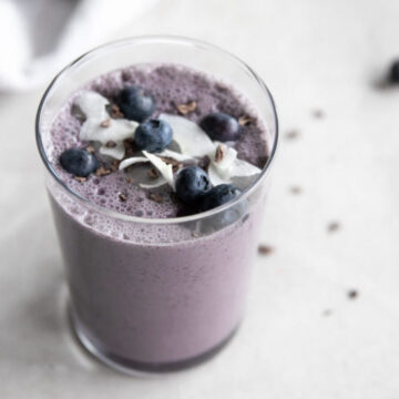 A glass of blueberry coconut smoothie