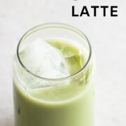 A glass of iced matcha latte, poured over ice.