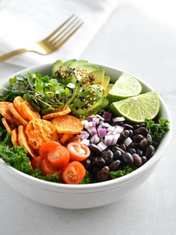A sweet potato black bean bowl with a fork in the background