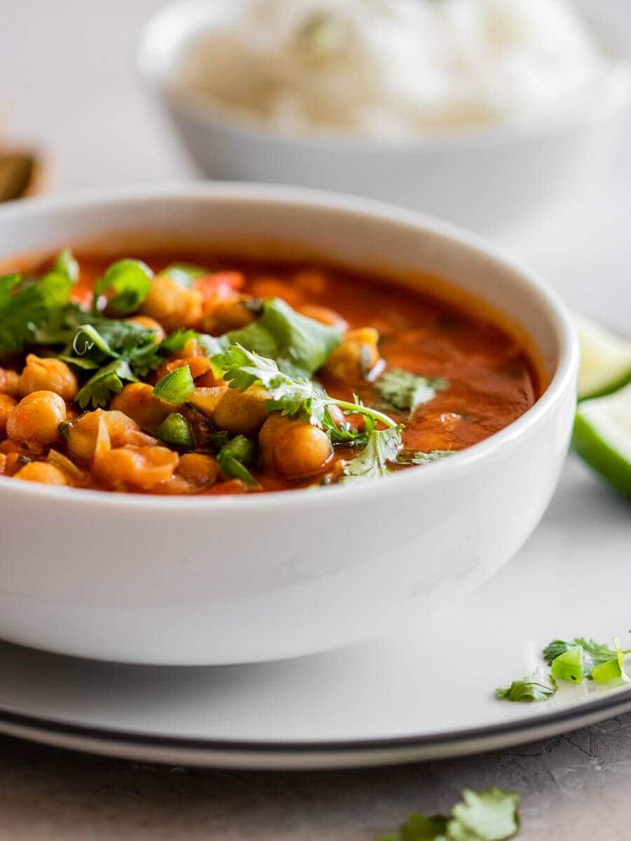 A delicious bowl of Indian chana masala., topped with fresh cilantro.