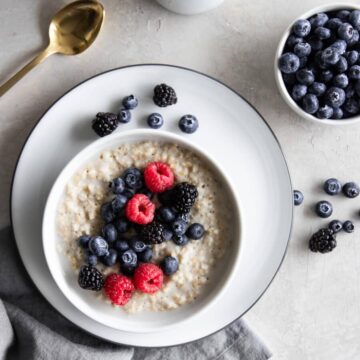 A bowl of overnight steel cut oats with fresh berries on top