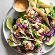 A platter of cauliflower tacos with sauce