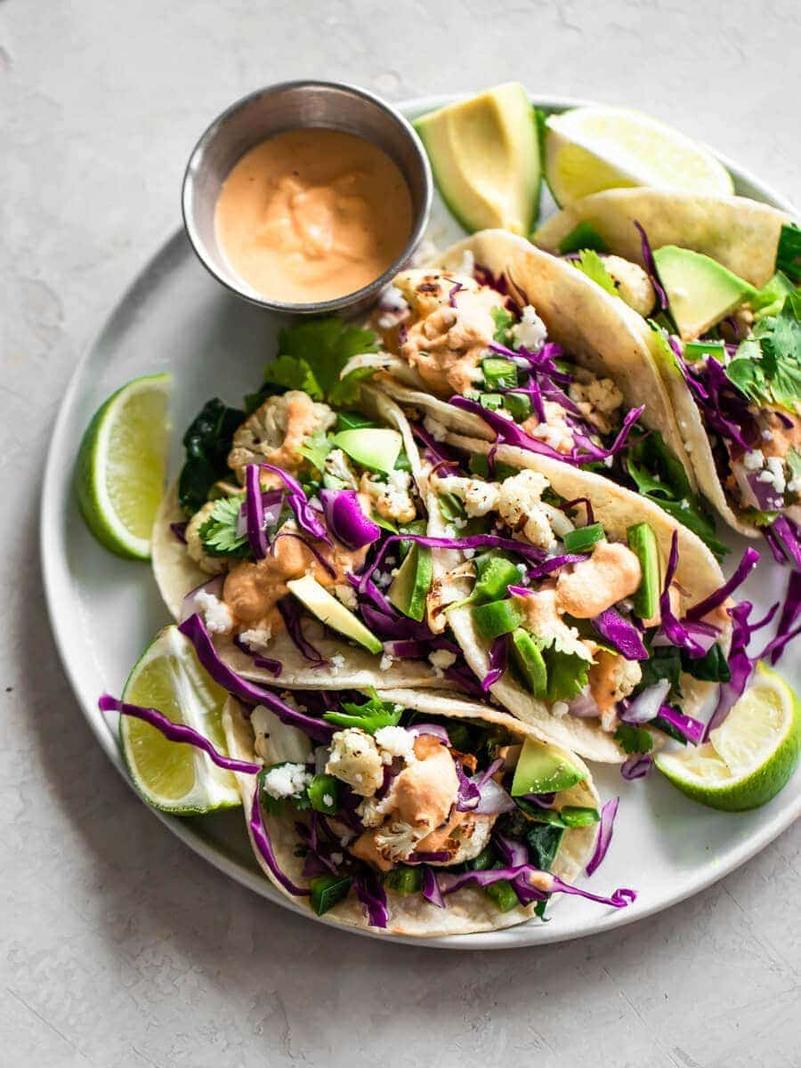 A platter of cauliflower tacos with sauce