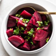 Bowl of beets with fresh herbs on top