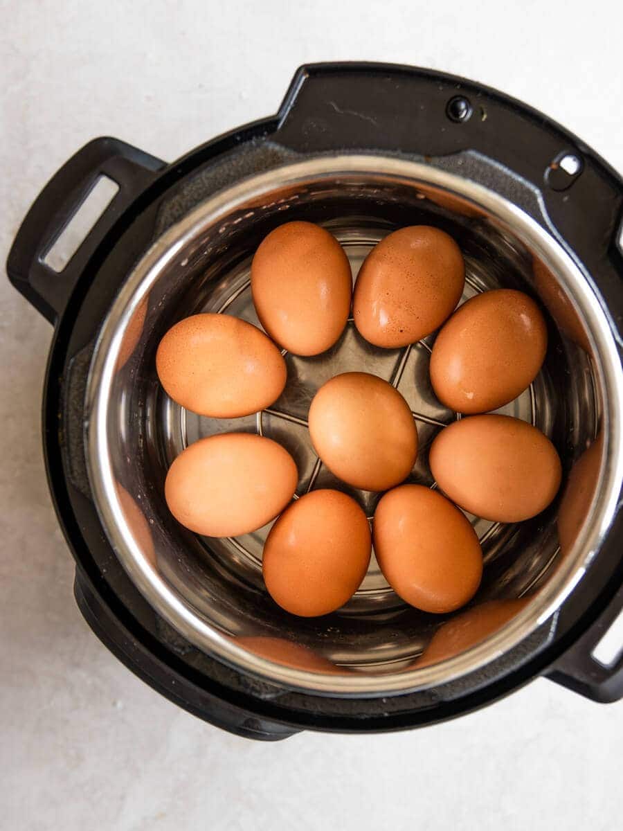 An Instant Pot filled with eggs sitting on the insert.