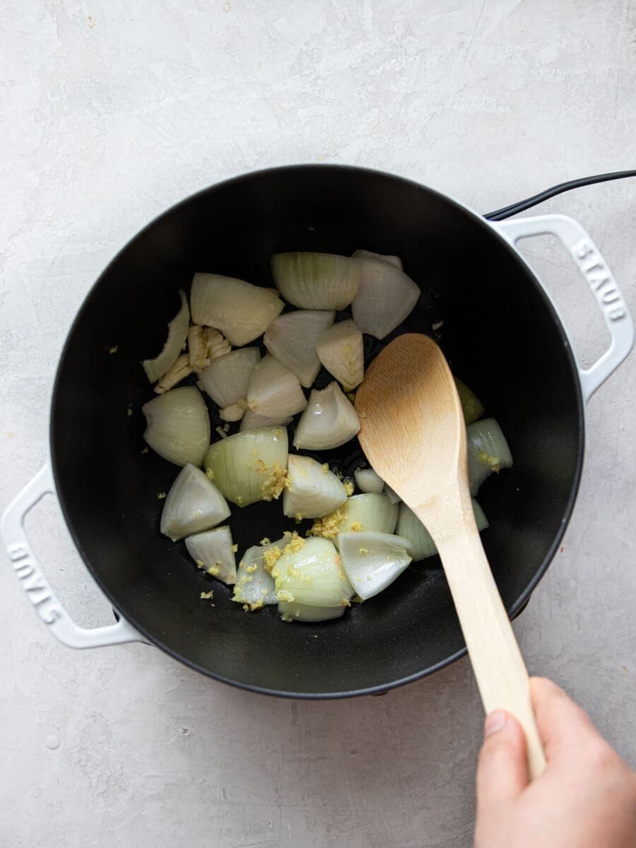 Onion, garlic, and ginger sautéing in pot.