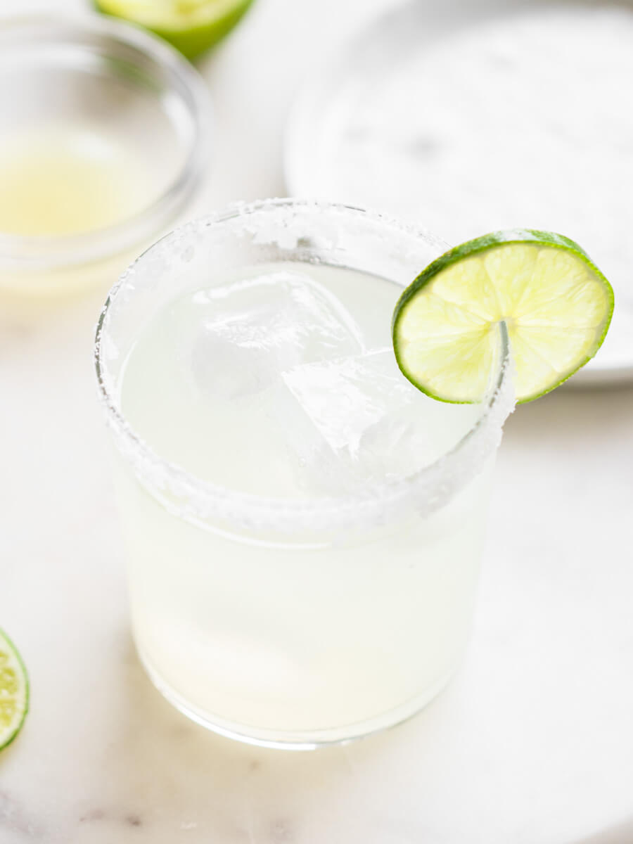 Classic margarita with a bowl of lime juice.