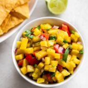 Bowl of mango salsa and chips on the side.