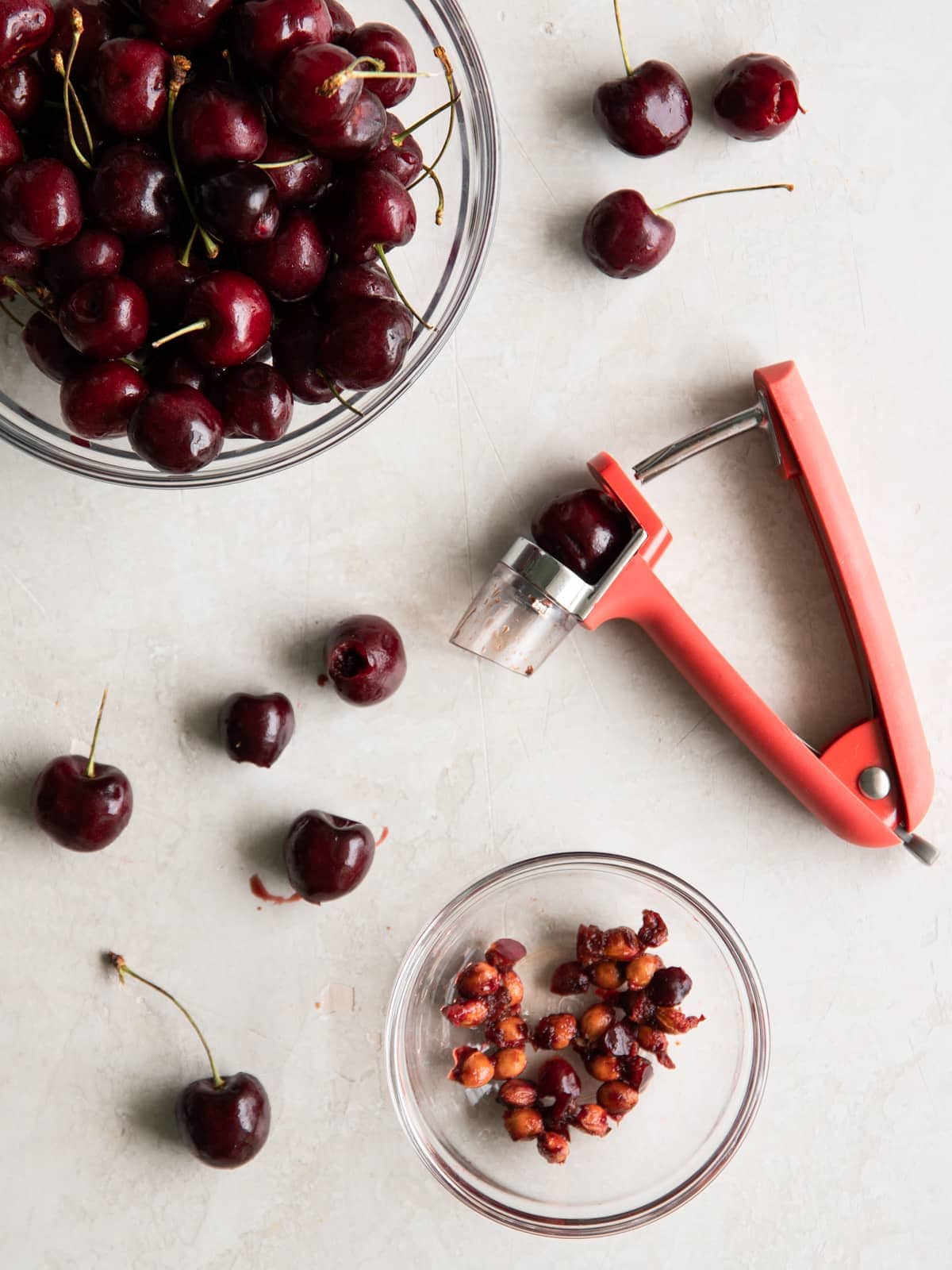 Bowl of cherries and a cherry pitter.