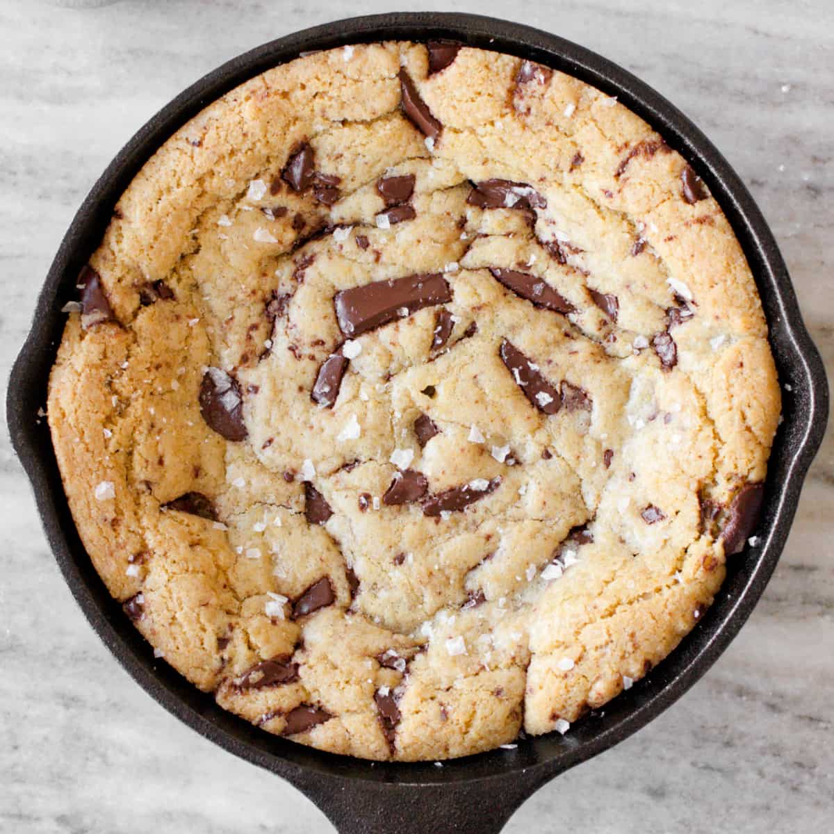 Baked mini skillet cookie with flaky salt sprinkled.