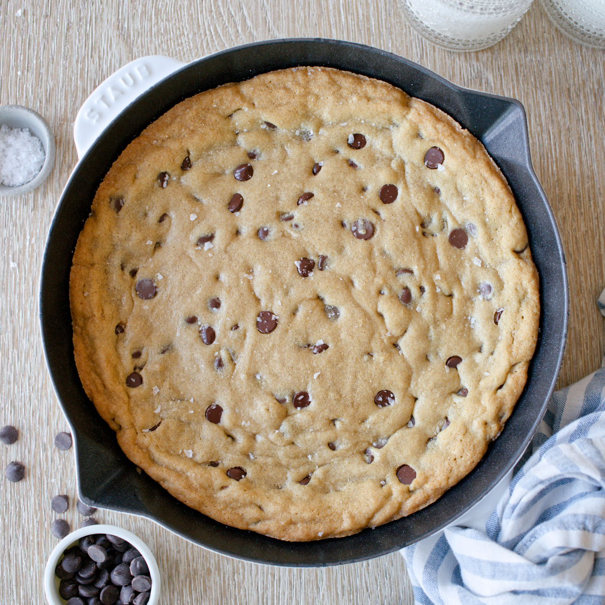 Baked skillet chocolate chip cookie sprinkled with flaked salt.