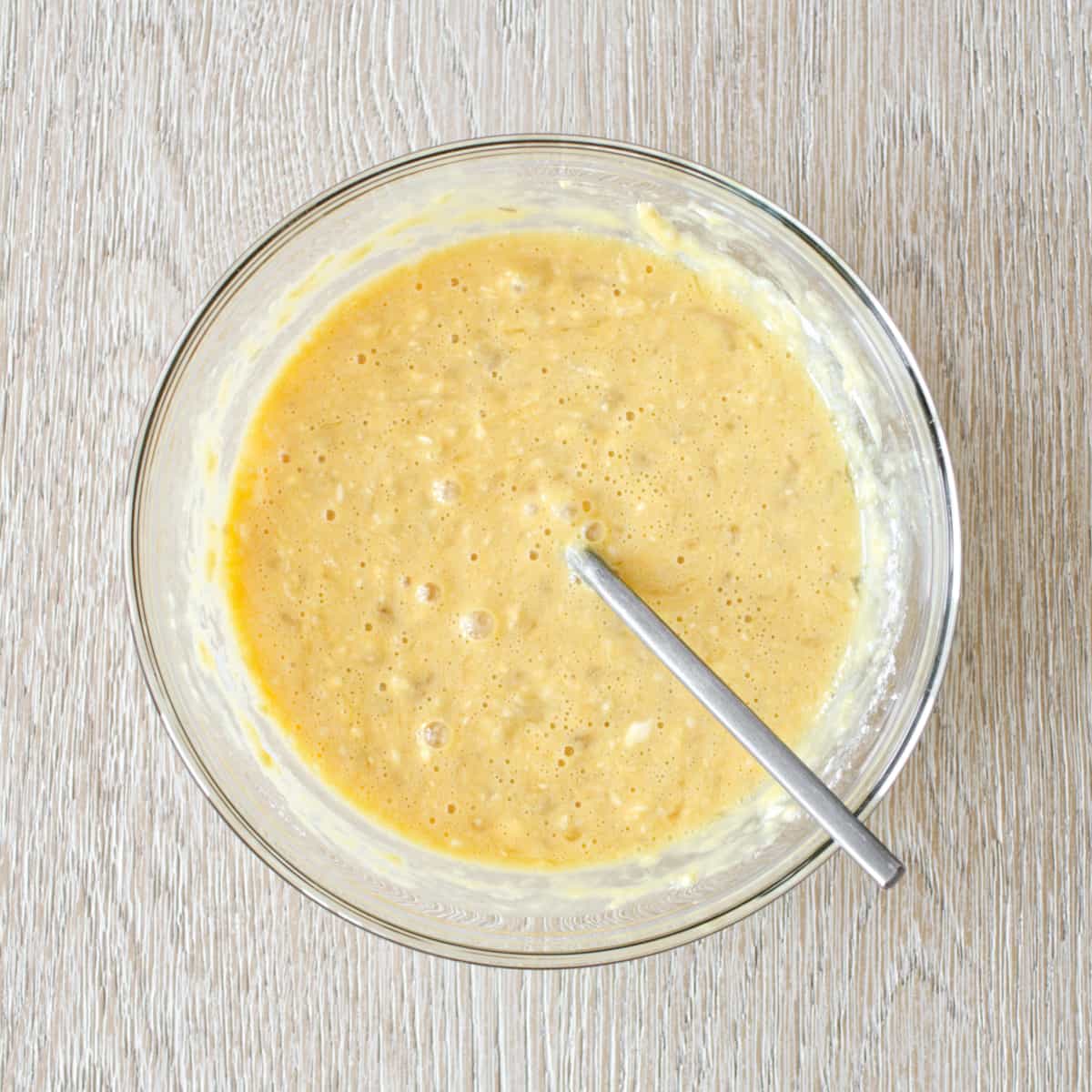 Banana pancake batter in medium bowl.