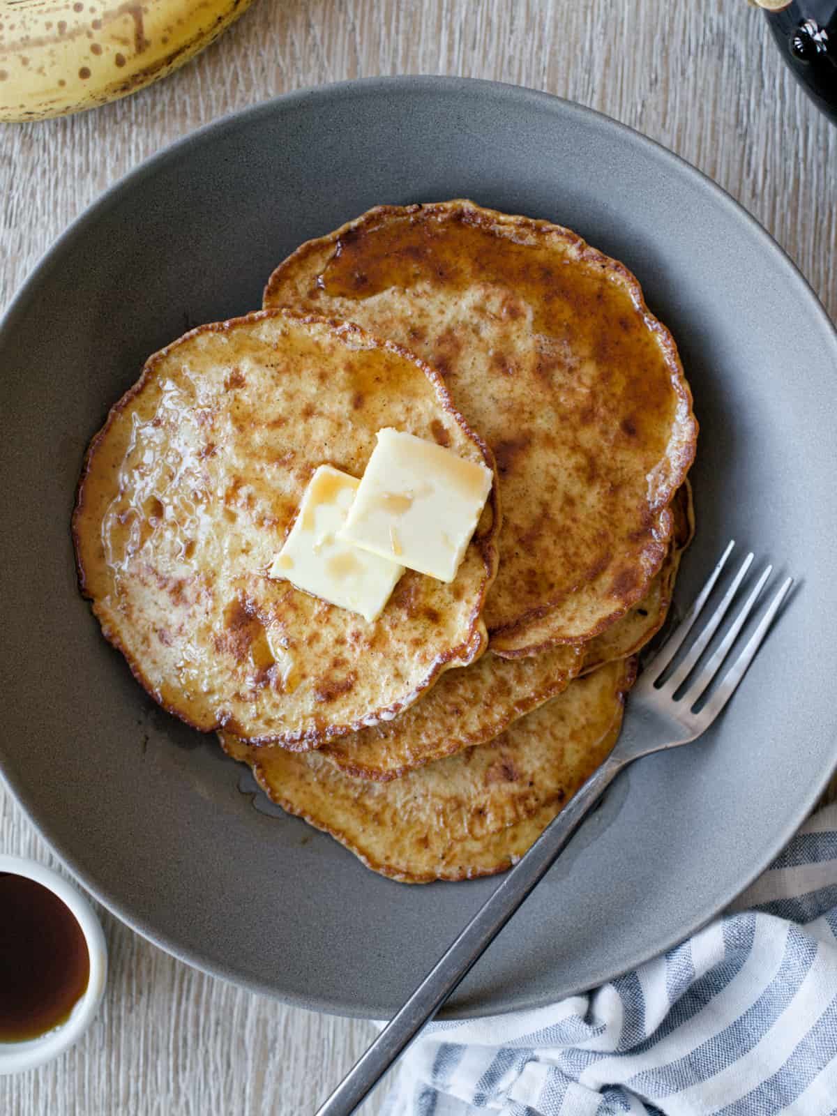 Banana pancakes on plate with fork.