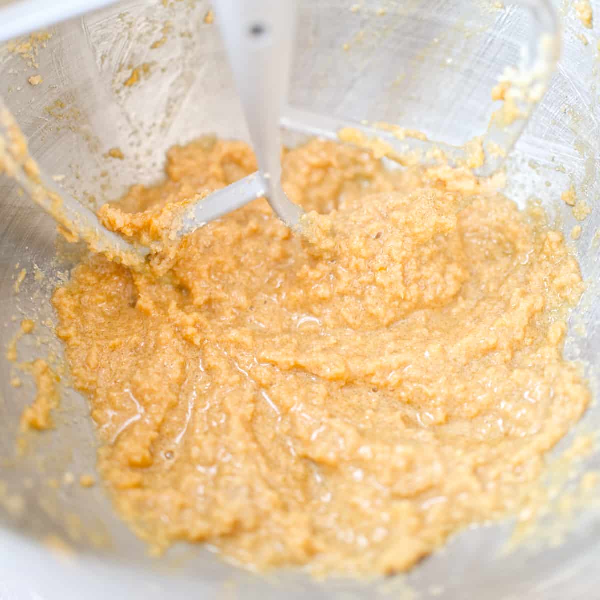 Batter mixed with eggs and extract in stand mixer bowl.