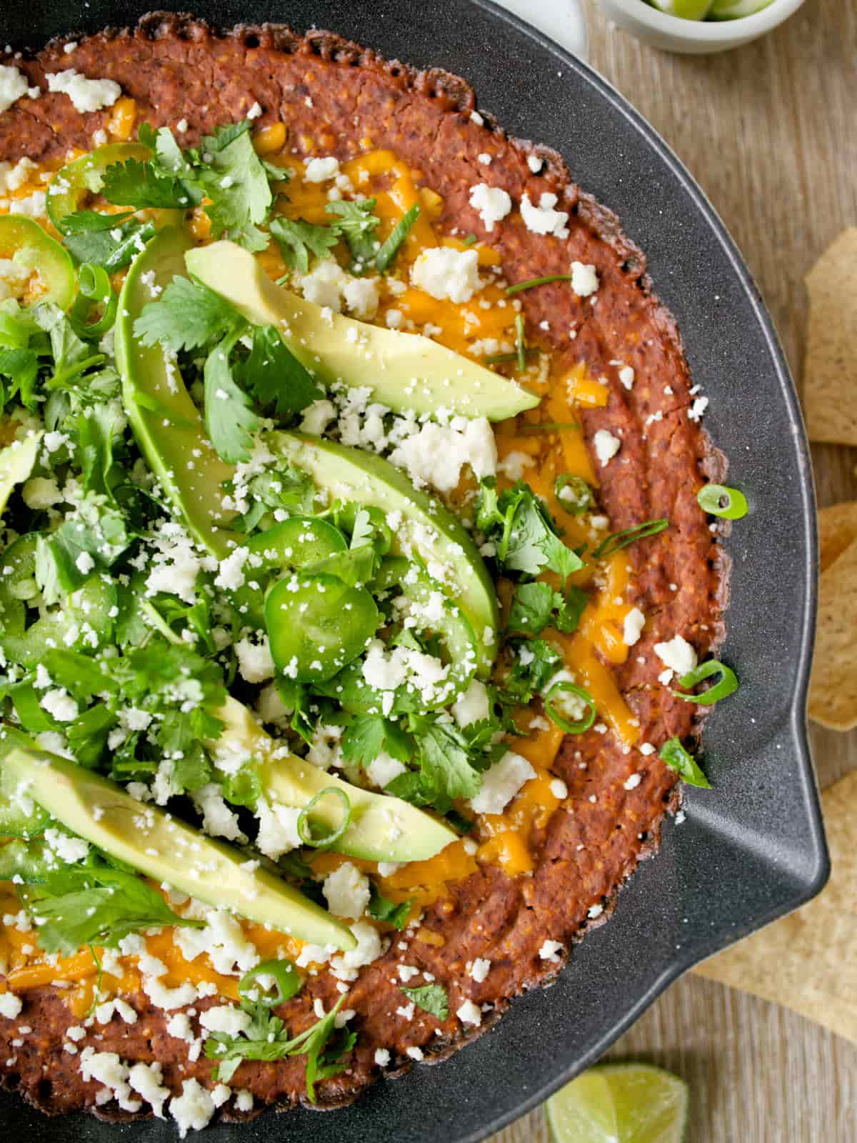 Close-up of black bean dip with toppings.
