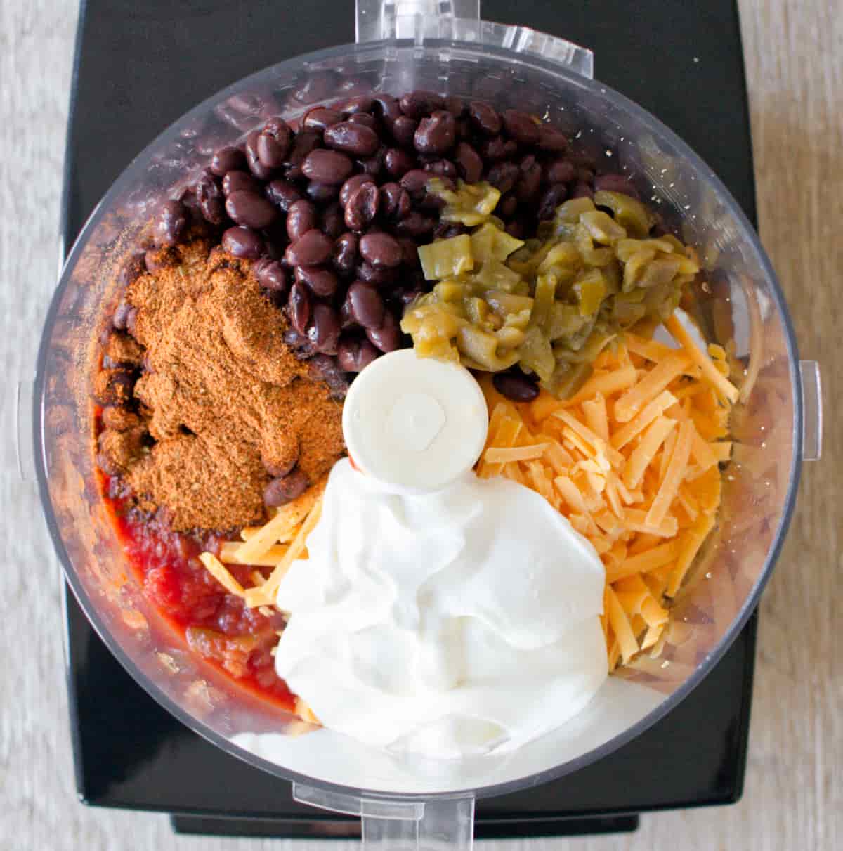 Ingredients for black bean dip in food processor.
