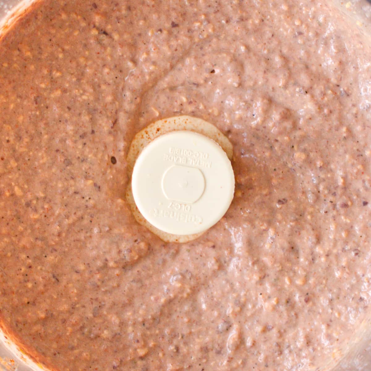 Close-up of processed black bean dip.