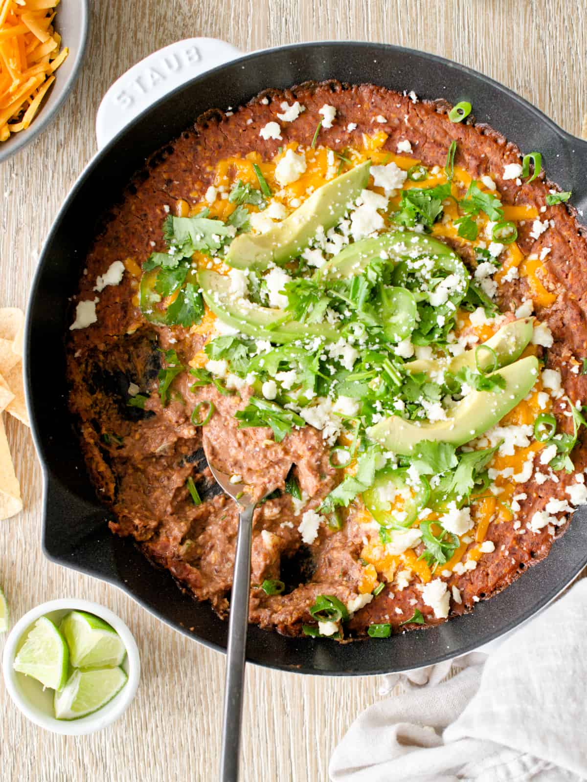 Black bean dip in skillet with spoon.