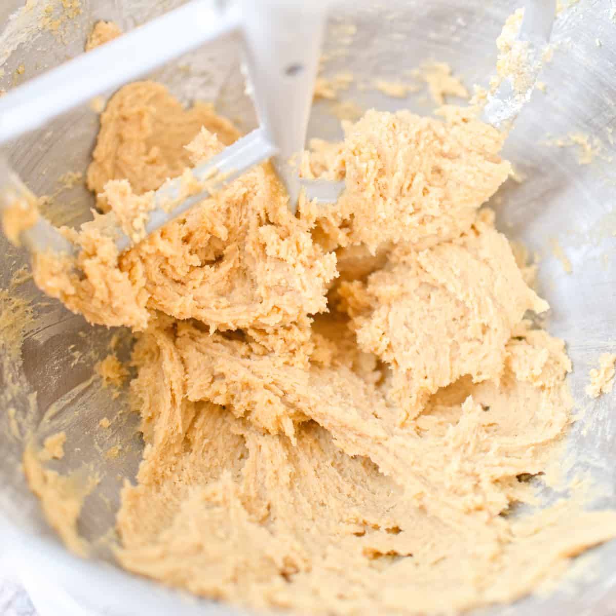 Cookie dough after adding flour in stand mixer bowl.