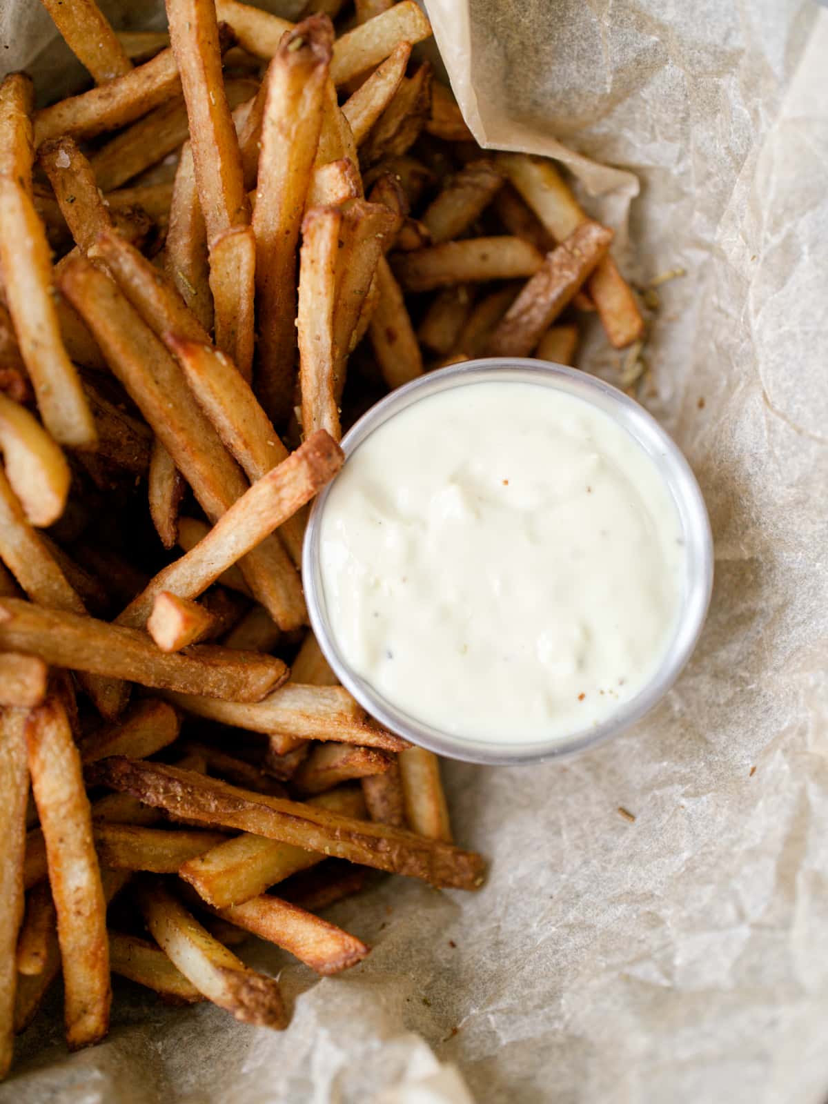 Close-up of garlic mayonnaise and fries.