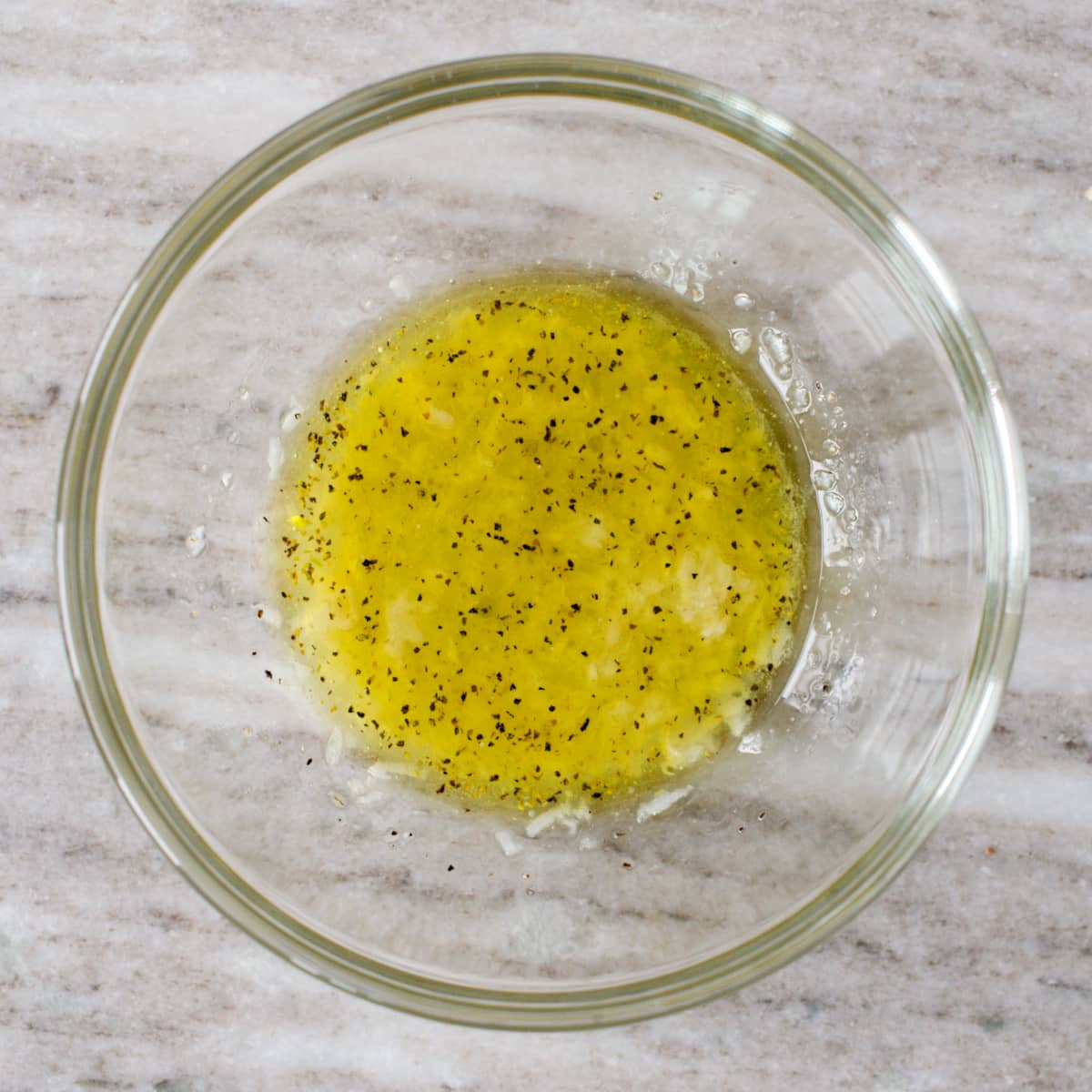 Small bowl with garlic, mayonnaise, lemon juice, and seasoning.