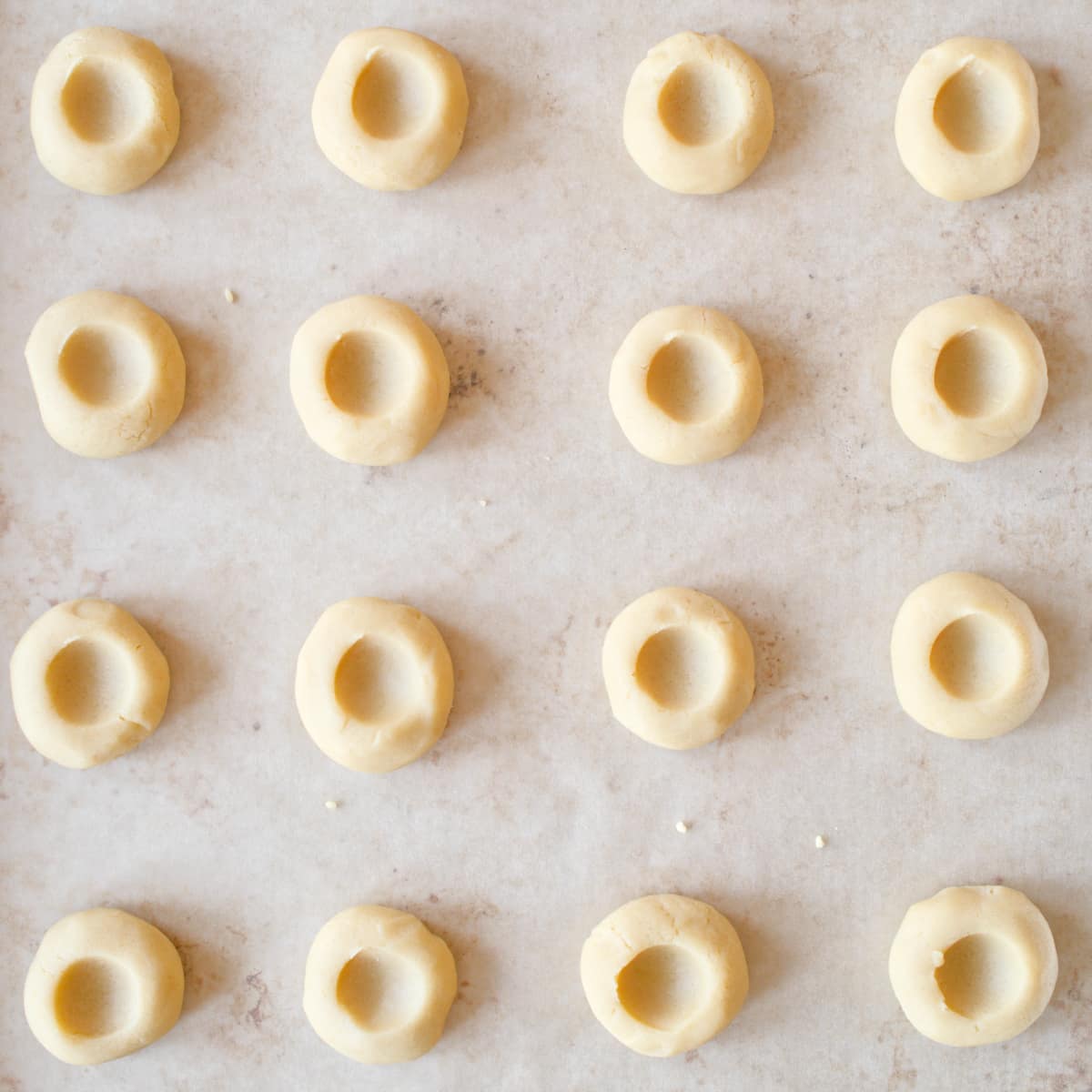 Thumbprint cookie balls with small indentations.