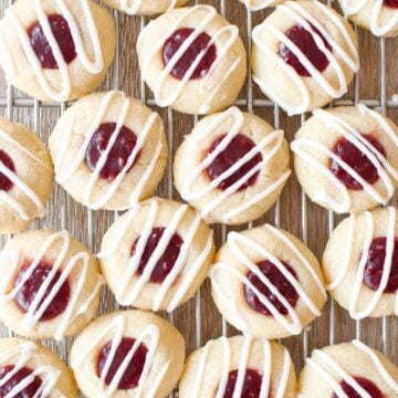 Close-up of raspberry thumbprint cookies with vanilla glaze.