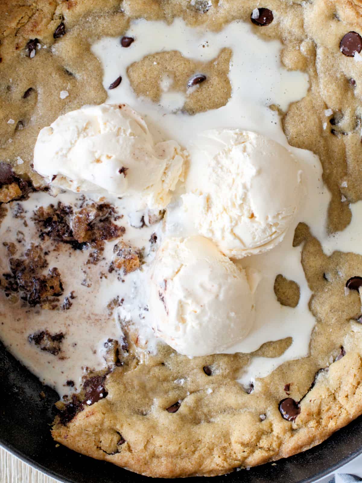 Close-up of skillet chocolate chip cookie with ice cream.