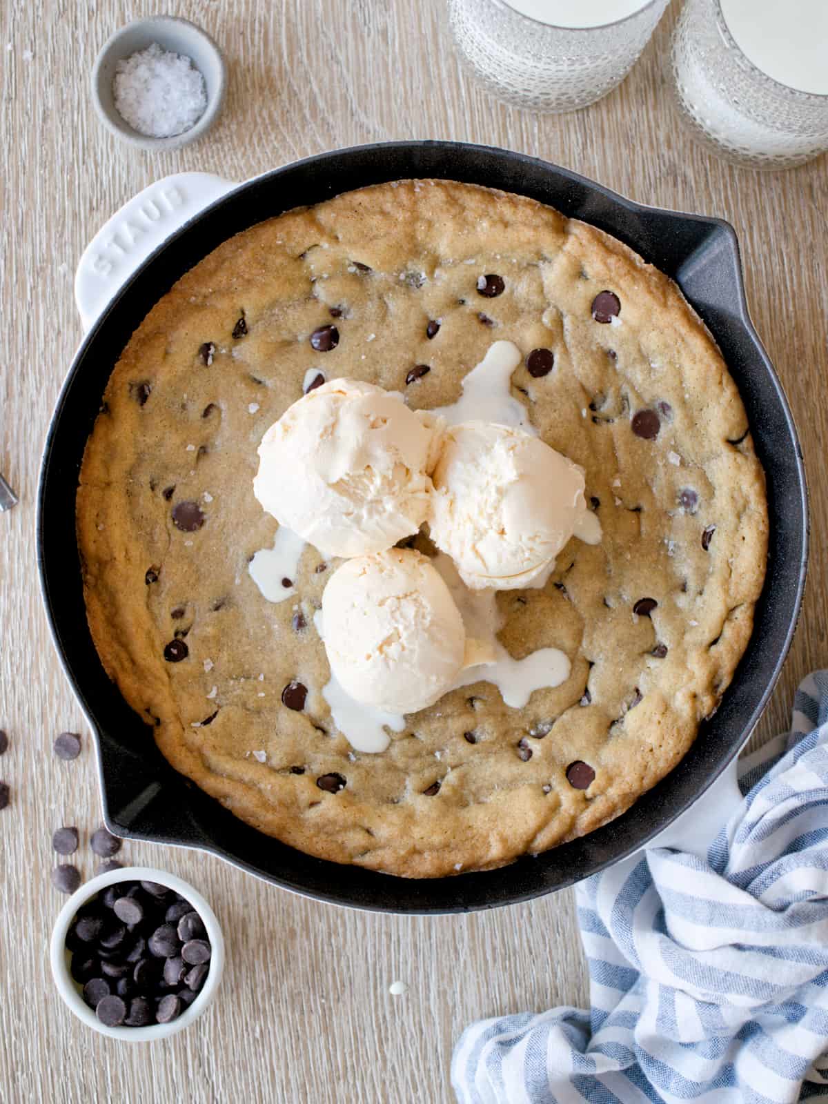 Baked skillet chocolate chip cookie with three scoops of ice cream.