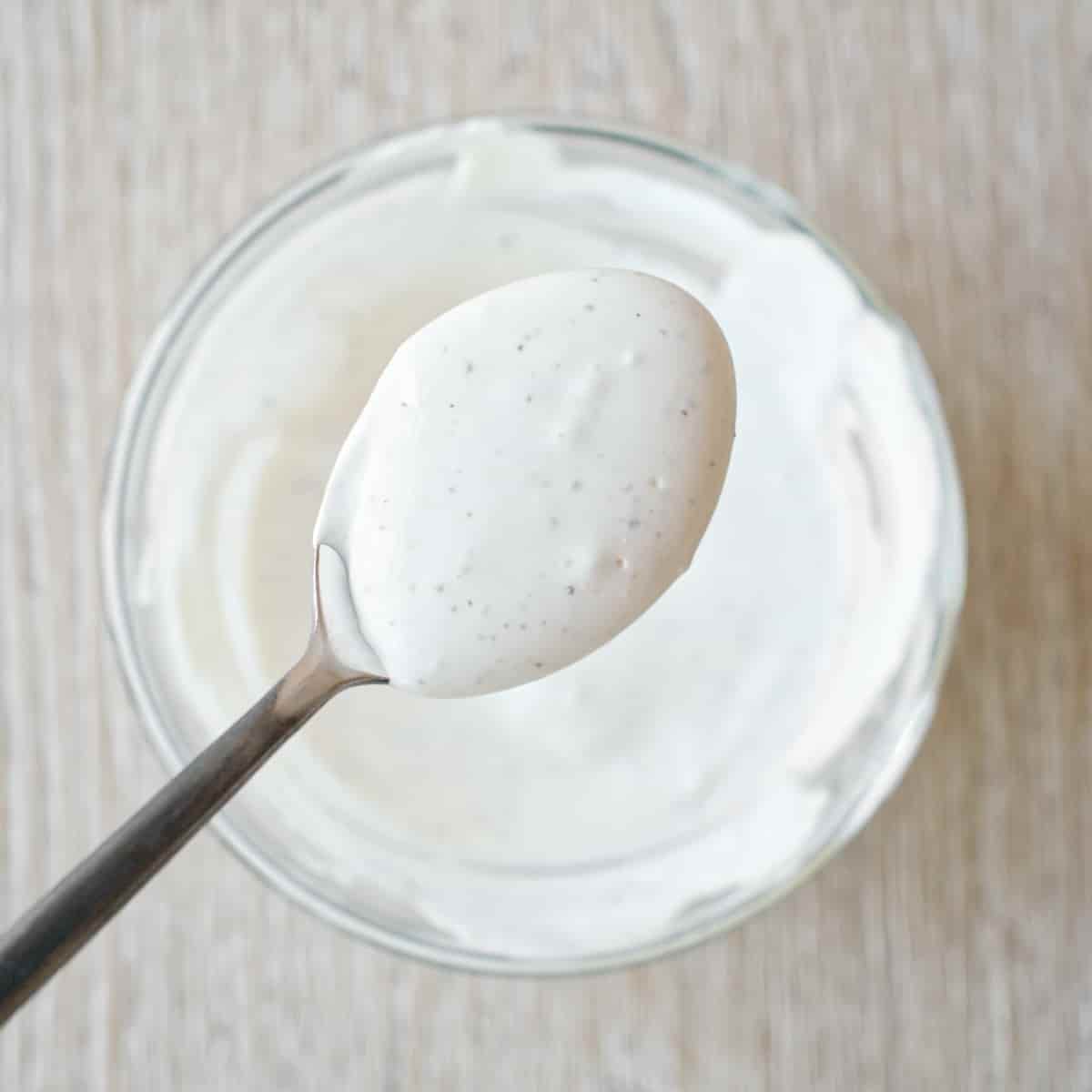 Close-up of spoon with taco slaw dressing.