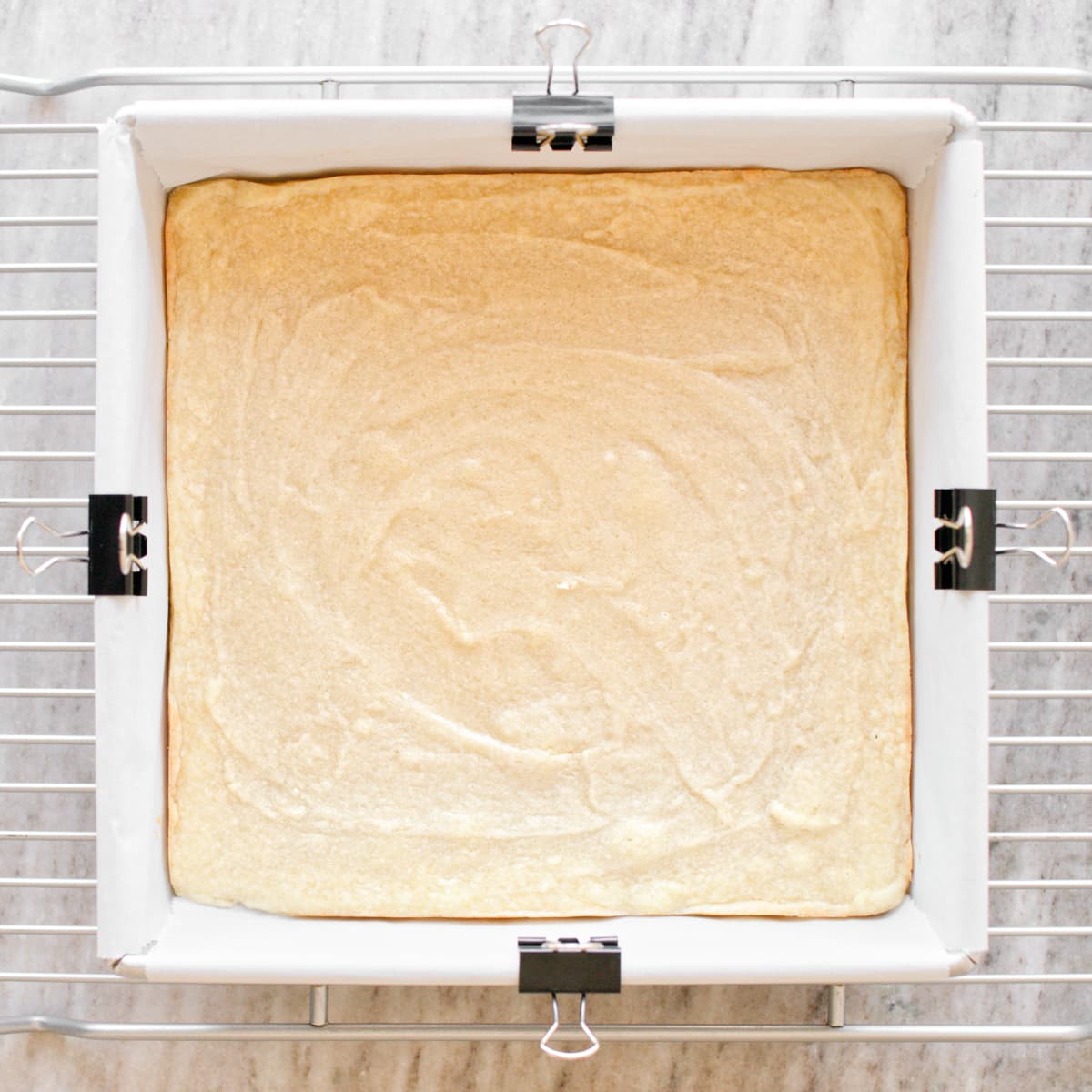 Baked sugar cookie bar on cooking rack.