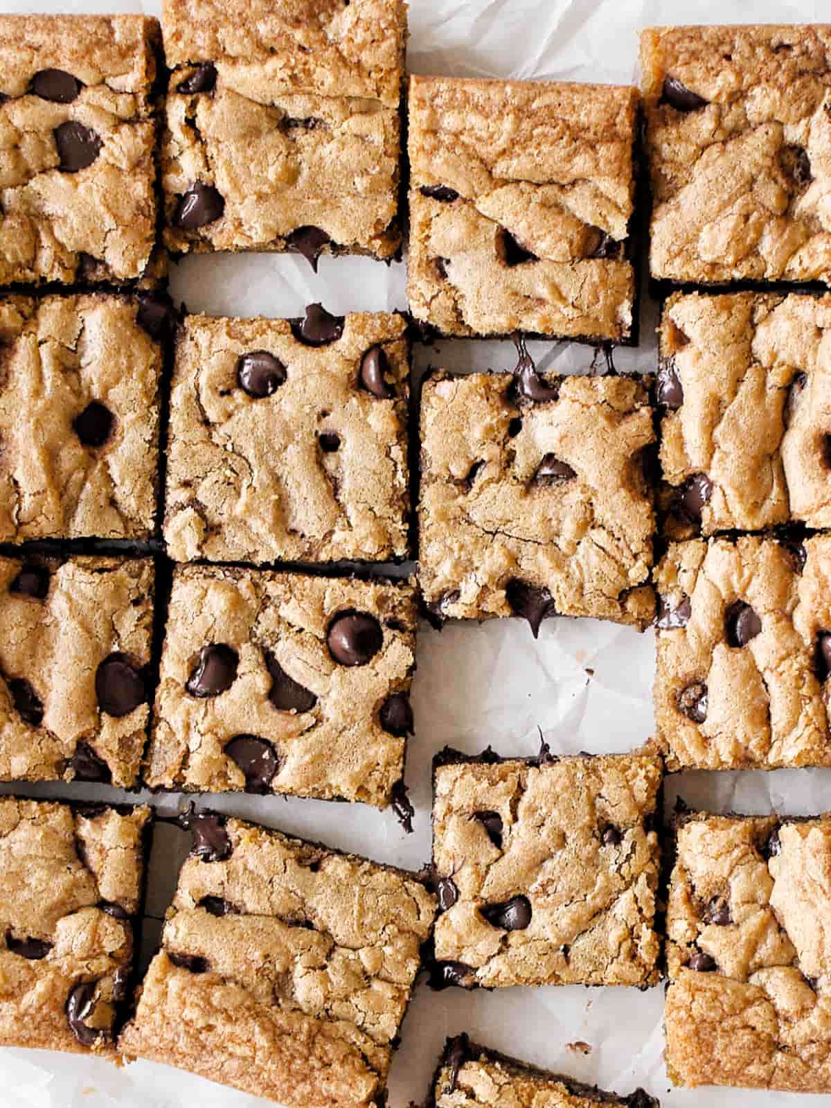 Chocolate chip cookie bars spread out.
