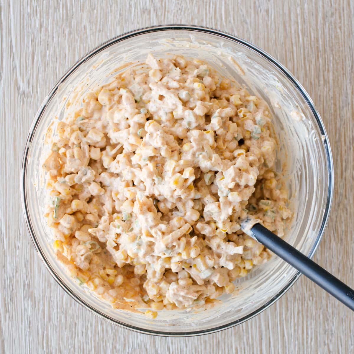 Corn dip in large glass bowl.