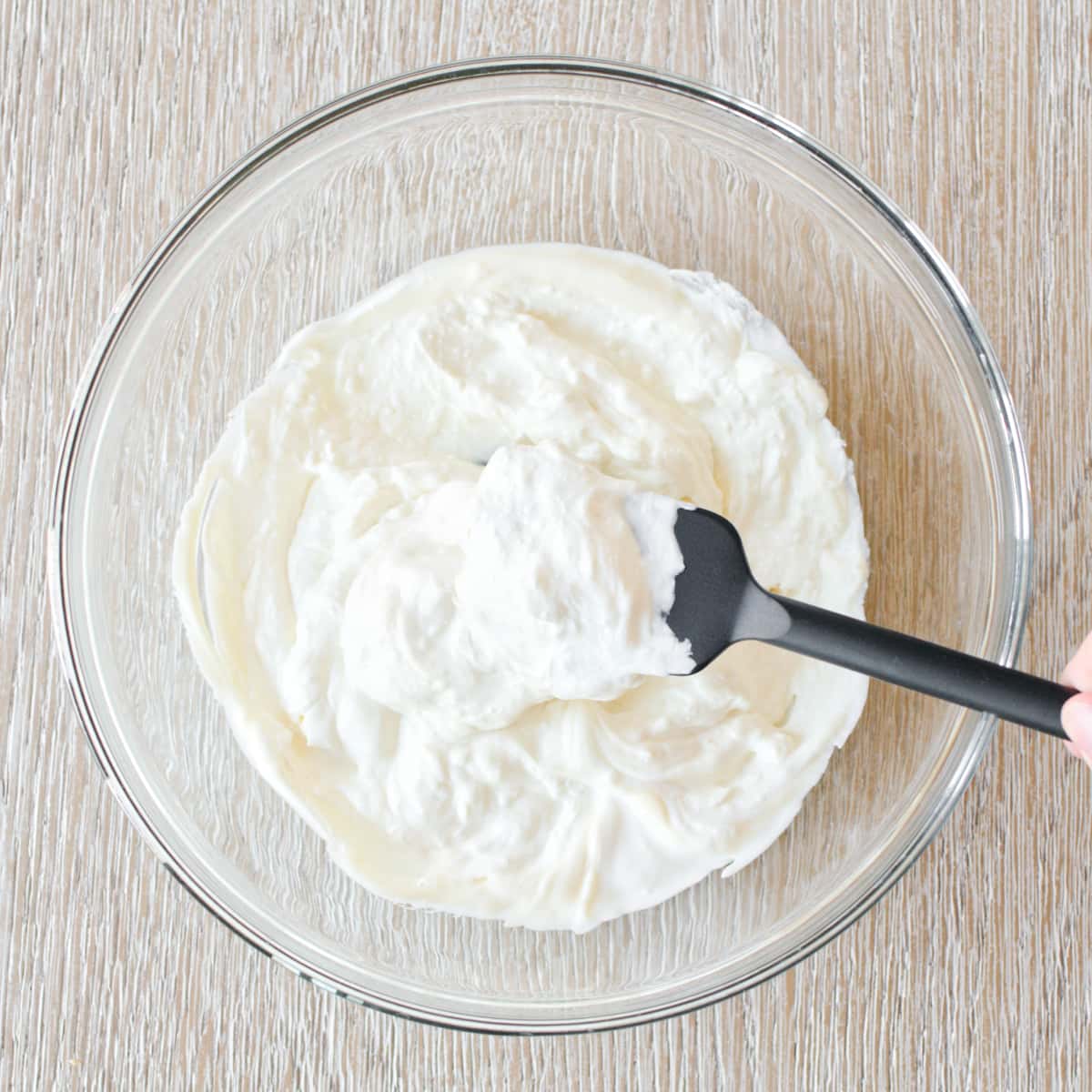 Mixture of sour cream, mayonnaise, and cream cheese in large bowl.