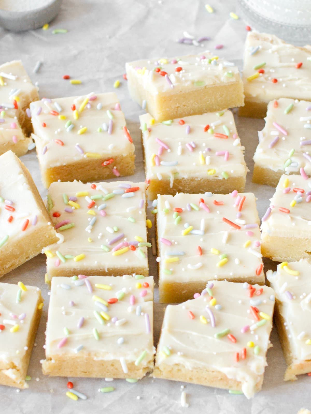 Side angle of sugar cookie bars on parchment paper.