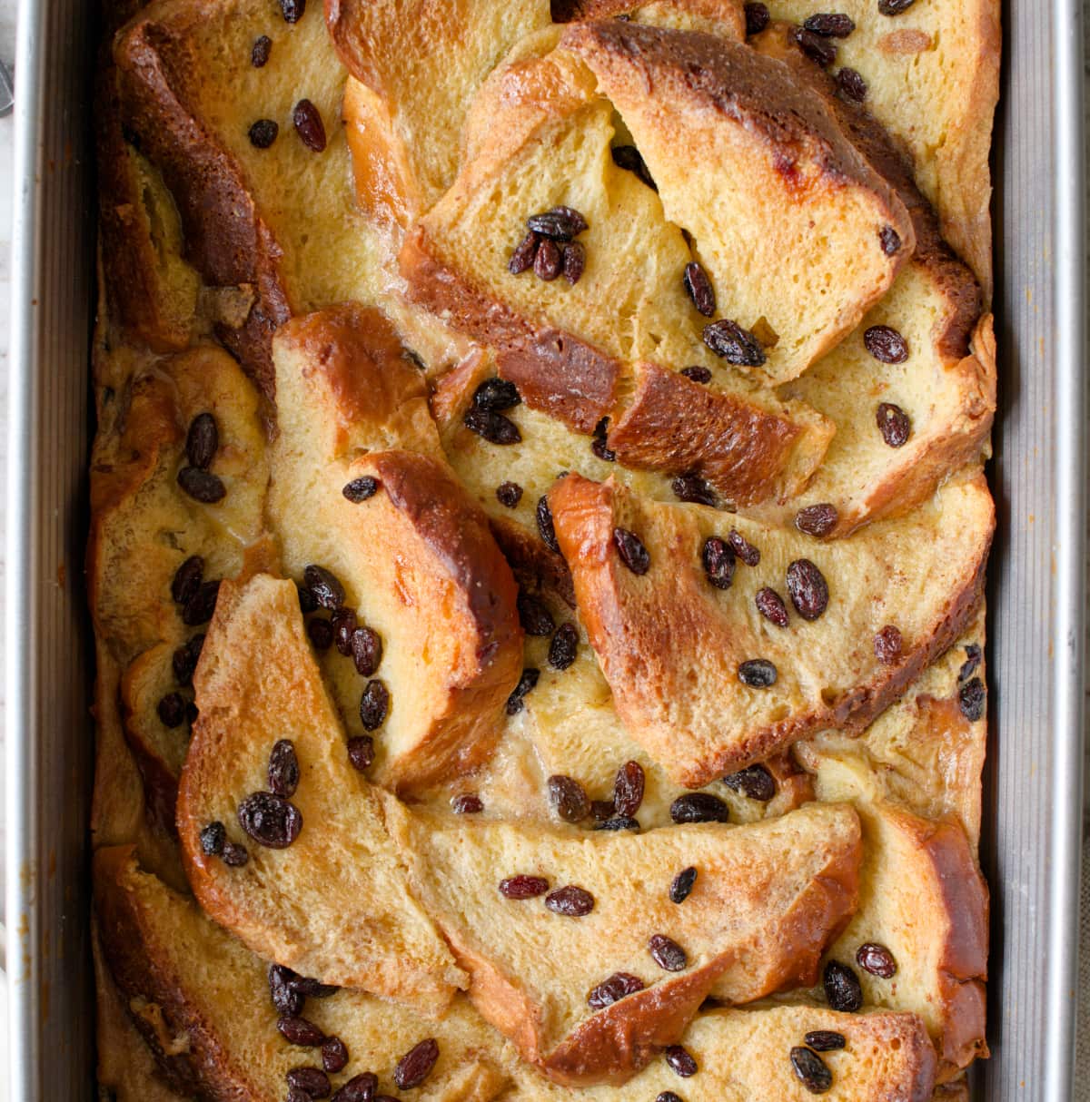 Baked bread and butter pudding in baking dish.