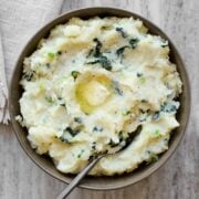 Colcannon in serving bowl with a knob of butter.