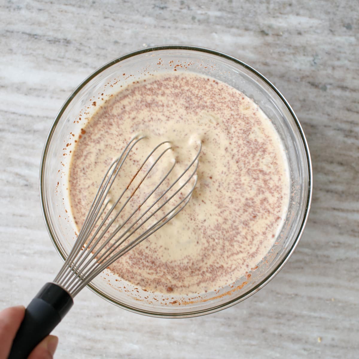 Whisking custard in large mixing bowl.
