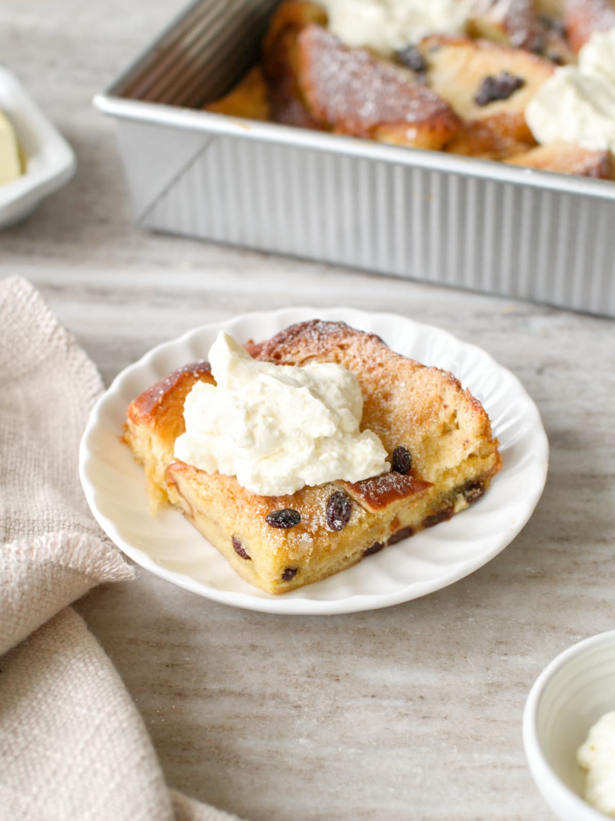 A pice of bread and butter pudding on a plate.